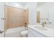 Well-lit bathroom with a tiled shower-tub combination and a modern vanity with a spacious countertop at 9322 Quaker St, Arvada, CO 80007