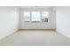 Bright, carpeted bedroom with multiple windows providing great natural light at 9322 Quaker St, Arvada, CO 80007