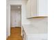 Butler's pantry with white cabinets, marble countertops, and hardware accents at 9322 Quaker St, Arvada, CO 80007