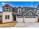 Charming two-story home featuring a 2-car garage and stone and vinyl siding at 9322 Quaker St, Arvada, CO 80007