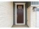 Close up of a modern front door with sidelight and exterior lighting at 9322 Quaker St, Arvada, CO 80007