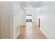 Open hallway leading to a bright living area with hardwood flooring at 9322 Quaker St, Arvada, CO 80007