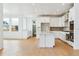 Bright and modern kitchen with a center island, stainless appliances, and white cabinetry at 9322 Quaker St, Arvada, CO 80007