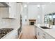 Open kitchen with stainless appliances, center island, and view into the living room at 9322 Quaker St, Arvada, CO 80007
