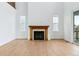 This bright living room features a gas fireplace and sliding glass doors to the deck at 9322 Quaker St, Arvada, CO 80007