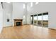 Spacious living room with a fireplace, high ceilings, and a sliding glass door to a deck at 9322 Quaker St, Arvada, CO 80007