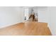 Open living room with wood floors, white trim, and staircase access to the second floor at 9322 Quaker St, Arvada, CO 80007