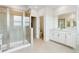 Bathroom features a glass shower, double sink vanity, and separate toilet room at 9322 Quaker St, Arvada, CO 80007