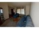 Cozy living room featuring a sofa, armchair, and window with patterned drapes at 2875 E 124Th Way, Thornton, CO 80241