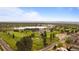 An elevated aerial view captures a beautiful golf course, picturesque lake, and distant mountains at 4625 W 50Th Ave # 304, Denver, CO 80212