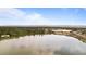 Expansive aerial view showcases a large lake surrounded by lush greenery and distant mountain views at 4625 W 50Th Ave # 304, Denver, CO 80212