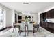Elegant dining room with a modern chandelier and a view of the open-concept kitchen at 4625 W 50Th Ave # 304, Denver, CO 80212