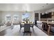Elegant dining area open to the kitchen, featuring a modern chandelier and access to outdoor terrace at 4625 W 50Th Ave # 304, Denver, CO 80212