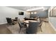 This game room has seating and tables for playing cards, as well as a pool table at 4625 W 50Th Ave # 304, Denver, CO 80212