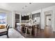 Open-concept kitchen featuring a large island with seating, stainless steel appliances, and hardwood floors at 4625 W 50Th Ave # 304, Denver, CO 80212