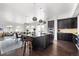 Spacious kitchen with dark cabinets, granite countertops, stainless appliances, and seamless flow to living area at 4625 W 50Th Ave # 304, Denver, CO 80212