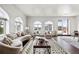 Bright living room with arched windows, hardwood floors, neutral décor, and access to the rooftop terrace at 4625 W 50Th Ave # 304, Denver, CO 80212