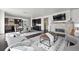Spacious living area with a stone fireplace, TV, open floor plan, and seamless access to kitchen and dining area at 4625 W 50Th Ave # 304, Denver, CO 80212