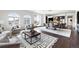 Open living area with arched windows, elegant furniture, dark wood floors and seamless flow to dining and kitchen at 4625 W 50Th Ave # 304, Denver, CO 80212
