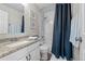 Clean bathroom featuring white cabinetry, granite countertops, and shower/tub combo at 12366 Nate Cir, Parker, CO 80134