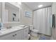 Bright bathroom featuring a vanity with solid surface countertops and a shower/tub combo at 12366 Nate Cir, Parker, CO 80134