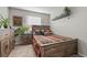 Cozy bedroom featuring a wood bed frame, colorful quilt, and decorative plants at 12366 Nate Cir, Parker, CO 80134