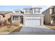 Two-story home featuring a two-car garage and light gray siding at 12366 Nate Cir, Parker, CO 80134