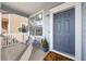 Inviting front porch features seating, a welcome mat, and a blue front door at 12366 Nate Cir, Parker, CO 80134