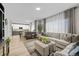 Open-concept living area with a large sectional sofa and a view of the modern kitchen at 12366 Nate Cir, Parker, CO 80134