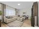Comfortable living room with a large sectional sofa, soft rug, and lots of natural light at 12366 Nate Cir, Parker, CO 80134