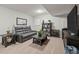 Basement rec room with a leather sofa, accent tables, and a large TV area at 12366 Nate Cir, Parker, CO 80134