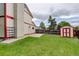 Backyard with a shed and green lawn, enclosed by a wooden fence, with mature trees nearby at 7552 Garland St, Arvada, CO 80005