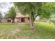 Backyard features a covered patio, mature trees, and a well-maintained lawn at 7552 Garland St, Arvada, CO 80005