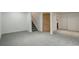 Finished basement with neutral carpet leading to stairs and closet at 7552 Garland St, Arvada, CO 80005