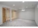 A spacious finished basement with neutral walls, carpet, and bright recessed lighting at 7552 Garland St, Arvada, CO 80005