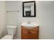 Cozy half bath features vanity with a dark framed mirror at 7552 Garland St, Arvada, CO 80005