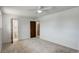 Neutral bedroom featuring a door to the ensuite bathroom and view of the closet at 7552 Garland St, Arvada, CO 80005