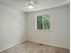 Neutral bedroom features a bright window and plush carpet for a clean and comfortable feel at 7552 Garland St, Arvada, CO 80005