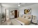Bedroom with neutral decor, a ceiling fan, and en-suite bathroom at 7552 Garland St, Arvada, CO 80005
