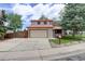 Charming two-story home with a brick facade, a two-car garage, and a well-maintained front yard at 7552 Garland St, Arvada, CO 80005