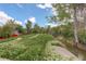 Scenic view of a grassy park with a stream, flowers and walking path at 7552 Garland St, Arvada, CO 80005