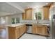 Kitchen boasts wood cabinets, stainless steel appliances, granite countertops, and a breakfast bar at 7552 Garland St, Arvada, CO 80005