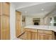Large kitchen with granite countertops, island, and wood cabinets at 7552 Garland St, Arvada, CO 80005
