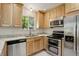 Updated kitchen with wood cabinets, granite countertops and stainless steel appliances at 7552 Garland St, Arvada, CO 80005