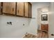 Laundry area with sink and cabinetry, situated conveniently near a half bathroom at 7552 Garland St, Arvada, CO 80005