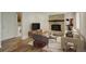 Cozy living room featuring a brick fireplace and tons of natural light at 7552 Garland St, Arvada, CO 80005