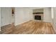 Bright living room featuring hardwood flooring and a classic brick fireplace with a dark wood mantel at 7552 Garland St, Arvada, CO 80005