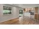 Bright and open living room and kitchen area, sliding door to the outside and large windows at 7552 Garland St, Arvada, CO 80005