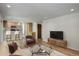 A spacious living room with an open kitchen area and modern decor at 7552 Garland St, Arvada, CO 80005