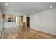 Bright open living room with updated flooring and an open layout with the kitchen at 7552 Garland St, Arvada, CO 80005